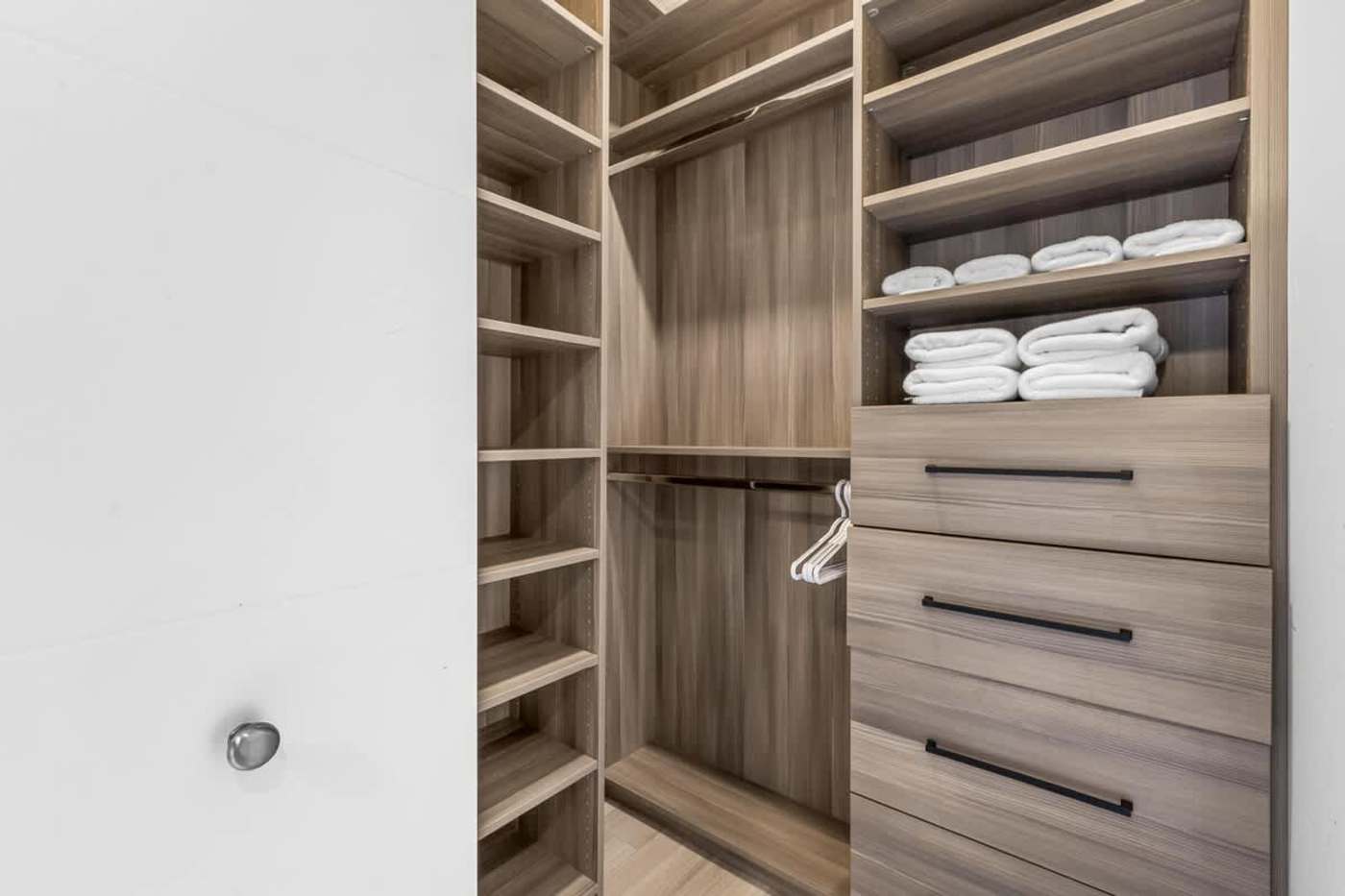 The Arcade House: Walk in wardrobe with drawers, shelving and fresh towels
