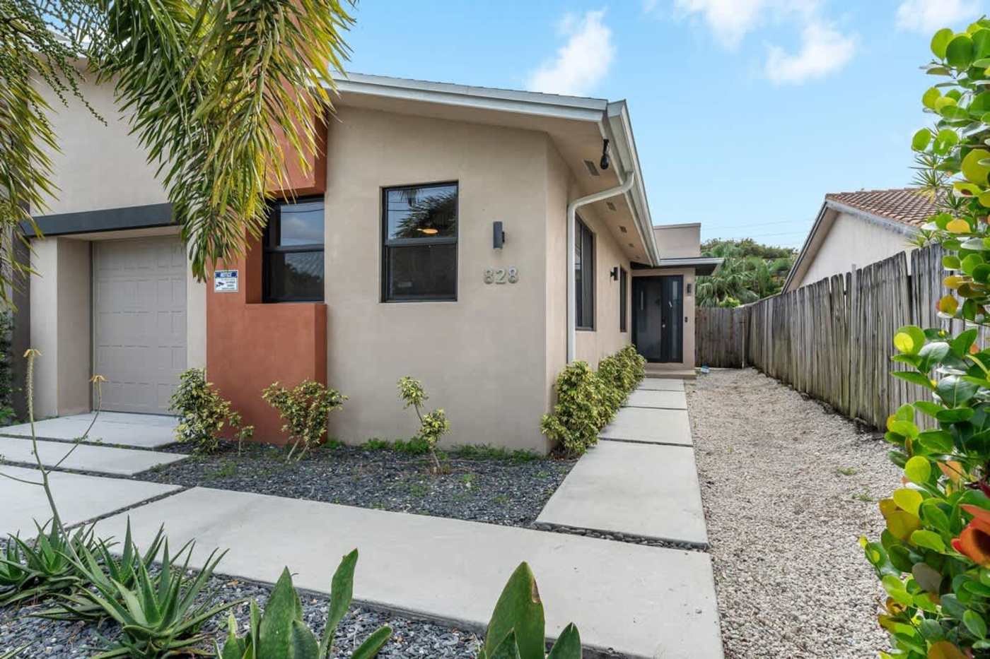 The Arcade House: The house from the street, with a stepping stone path to the door