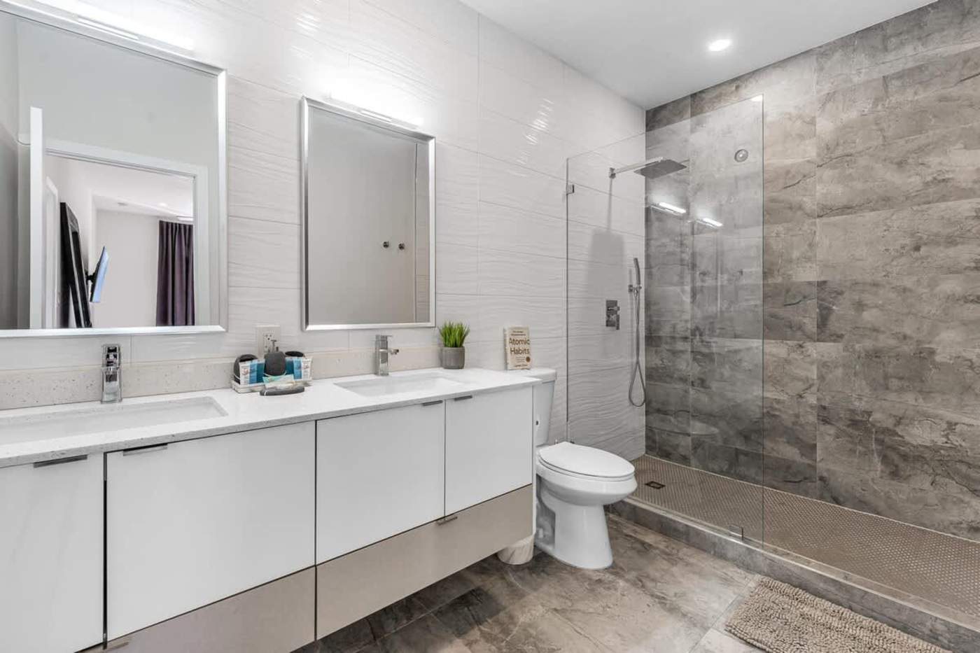 The Arcade House: Bathroom with double vanity, twin mirrors and a walk in shower