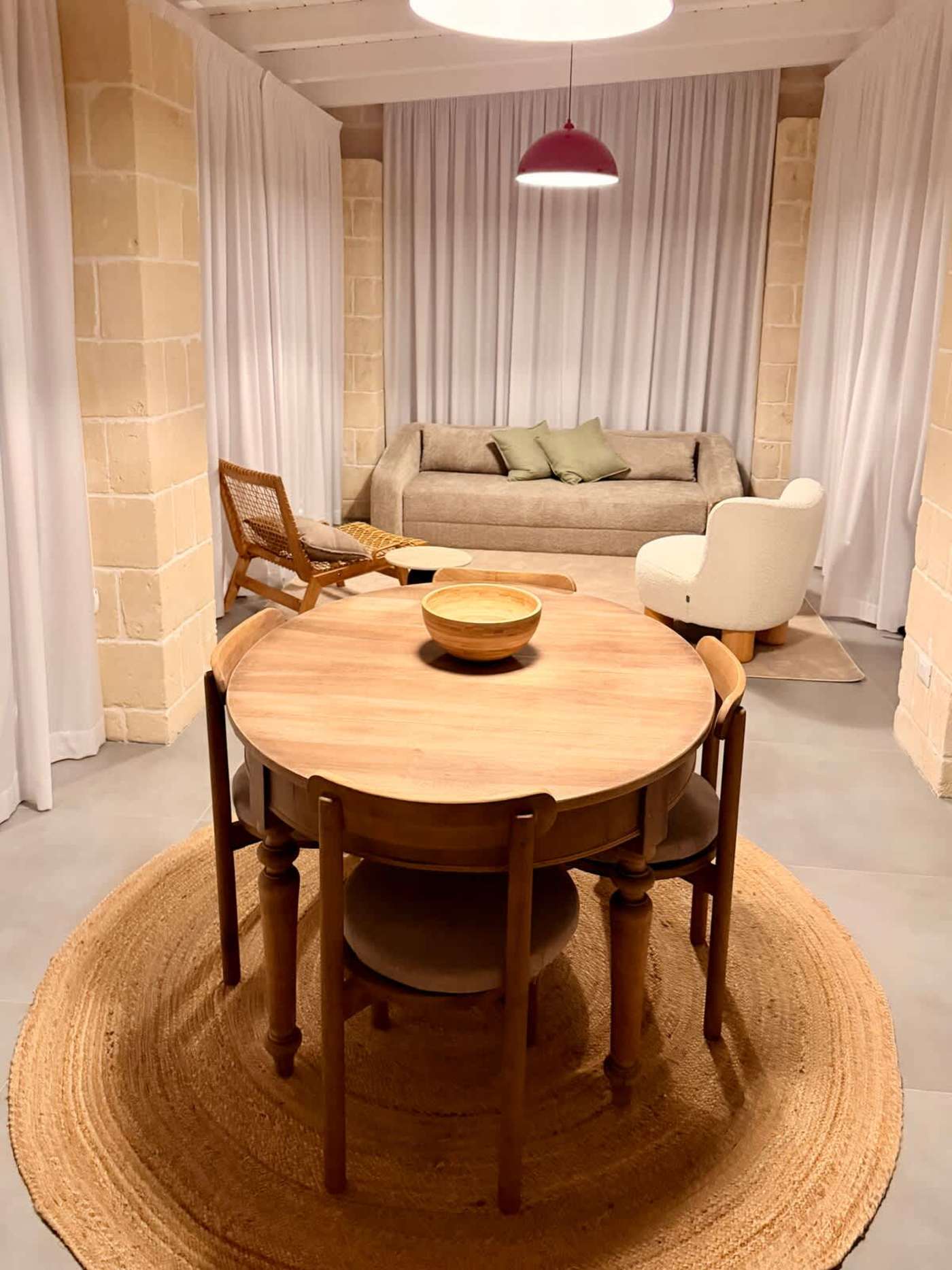 Trullo Ostro: Dining table for four with living room sofa behind
