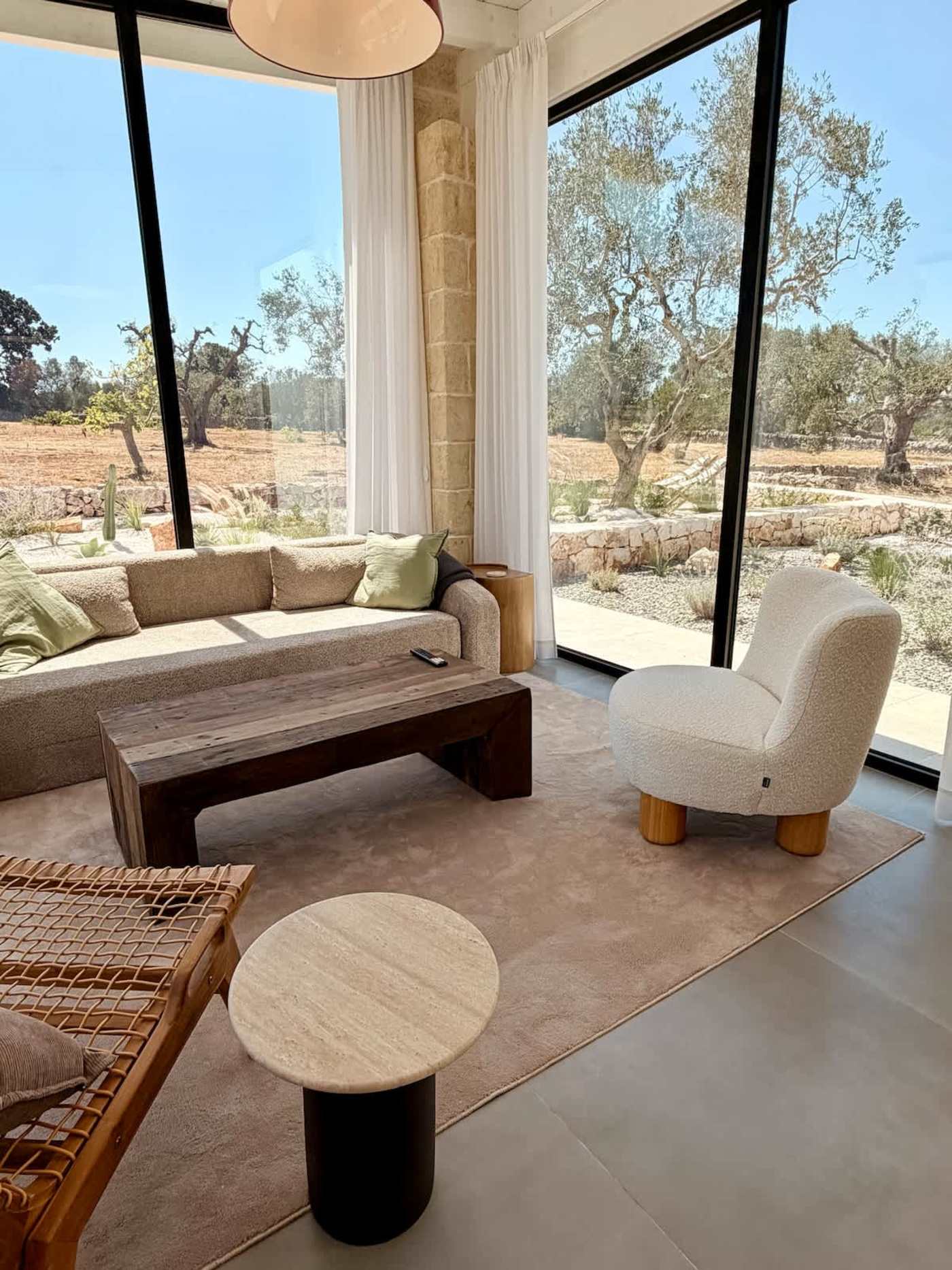 Trullo Ostro: Living room with sofa, armchair and olive grove views