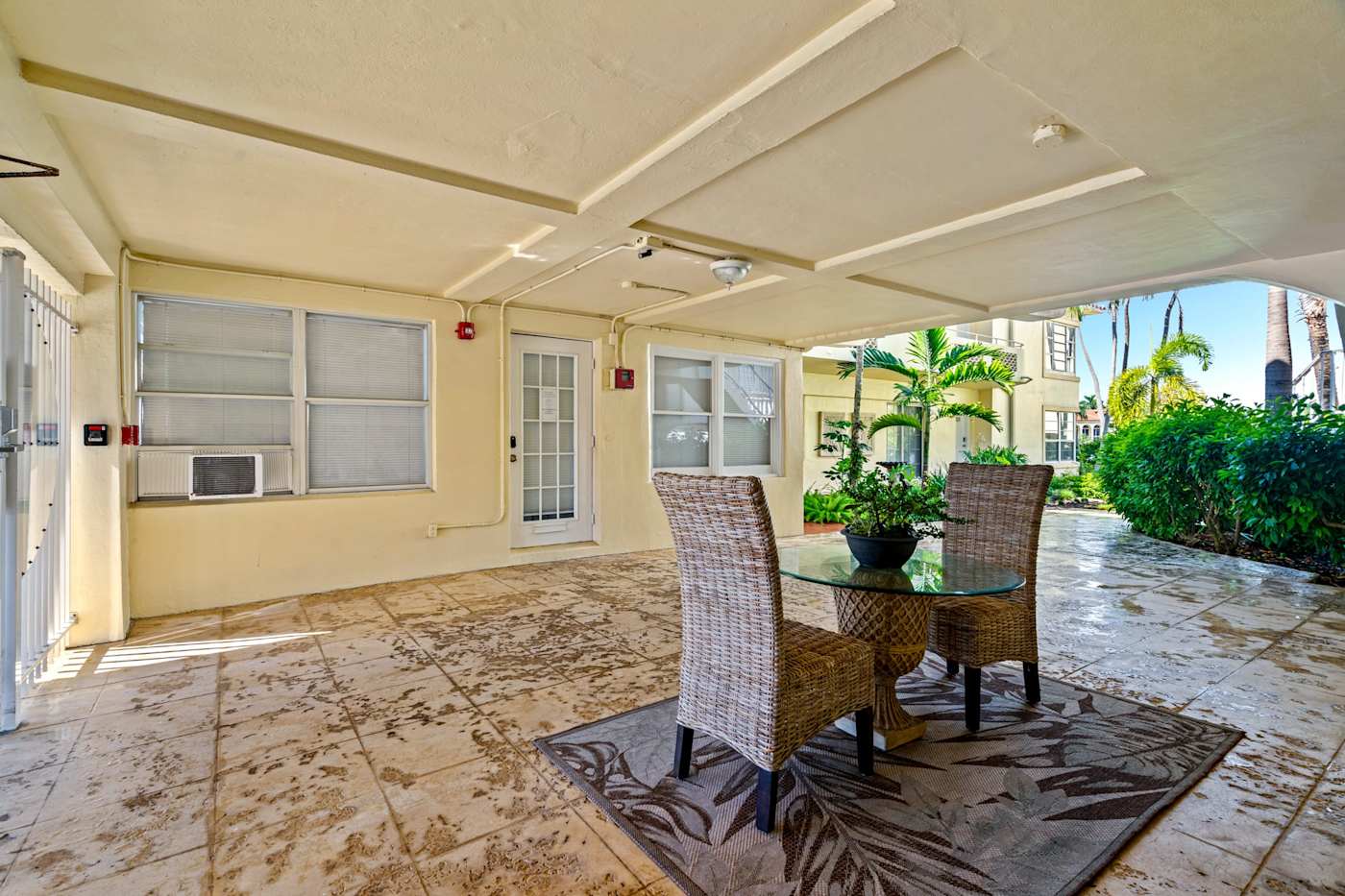 Ocean Block: A covered patio in the building has a small table and two chairs