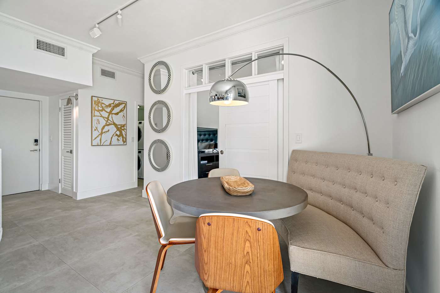 Ocean Block: The dining nook has a tufted banquette and seating for four