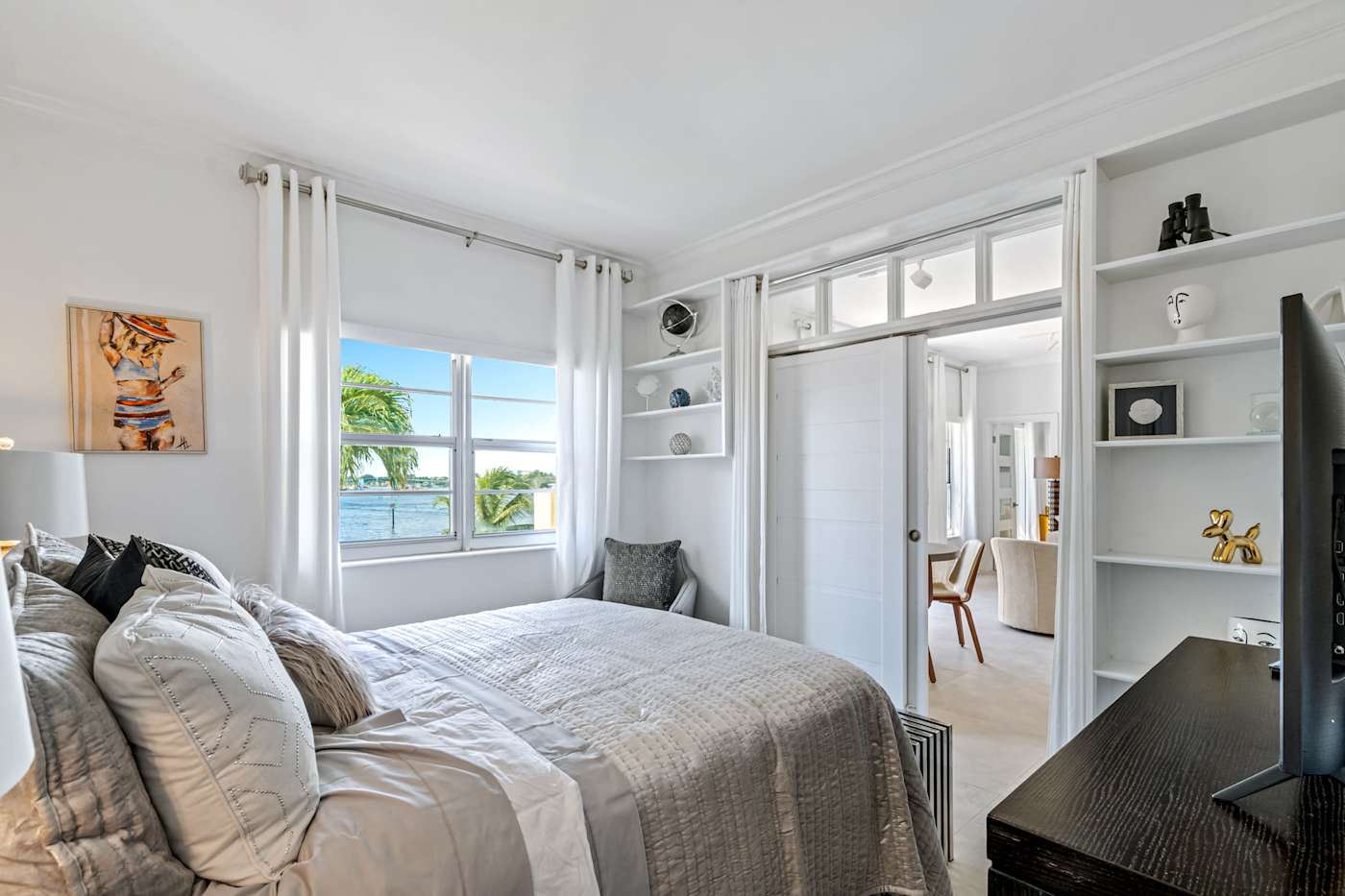 Ocean Block: This bedroom has a bed, built-in shelves and a window with a water view