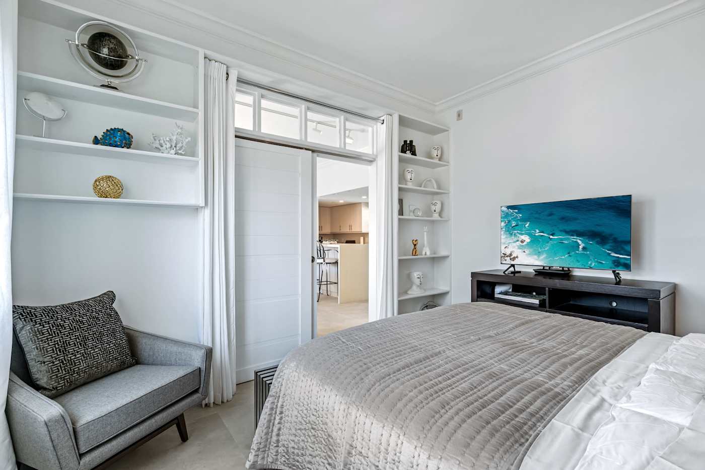 Ocean Block: This bedroom has a bed, a TV, an armchair and built-in shelves