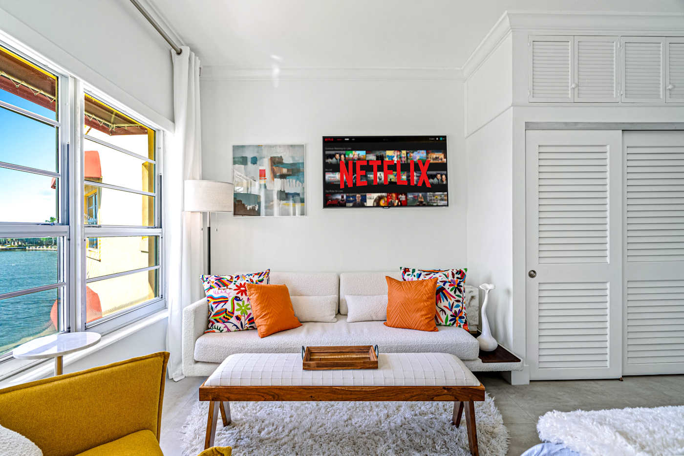 Ocean Block: This sitting area has a sofa, a Smart TV and windows facing the water