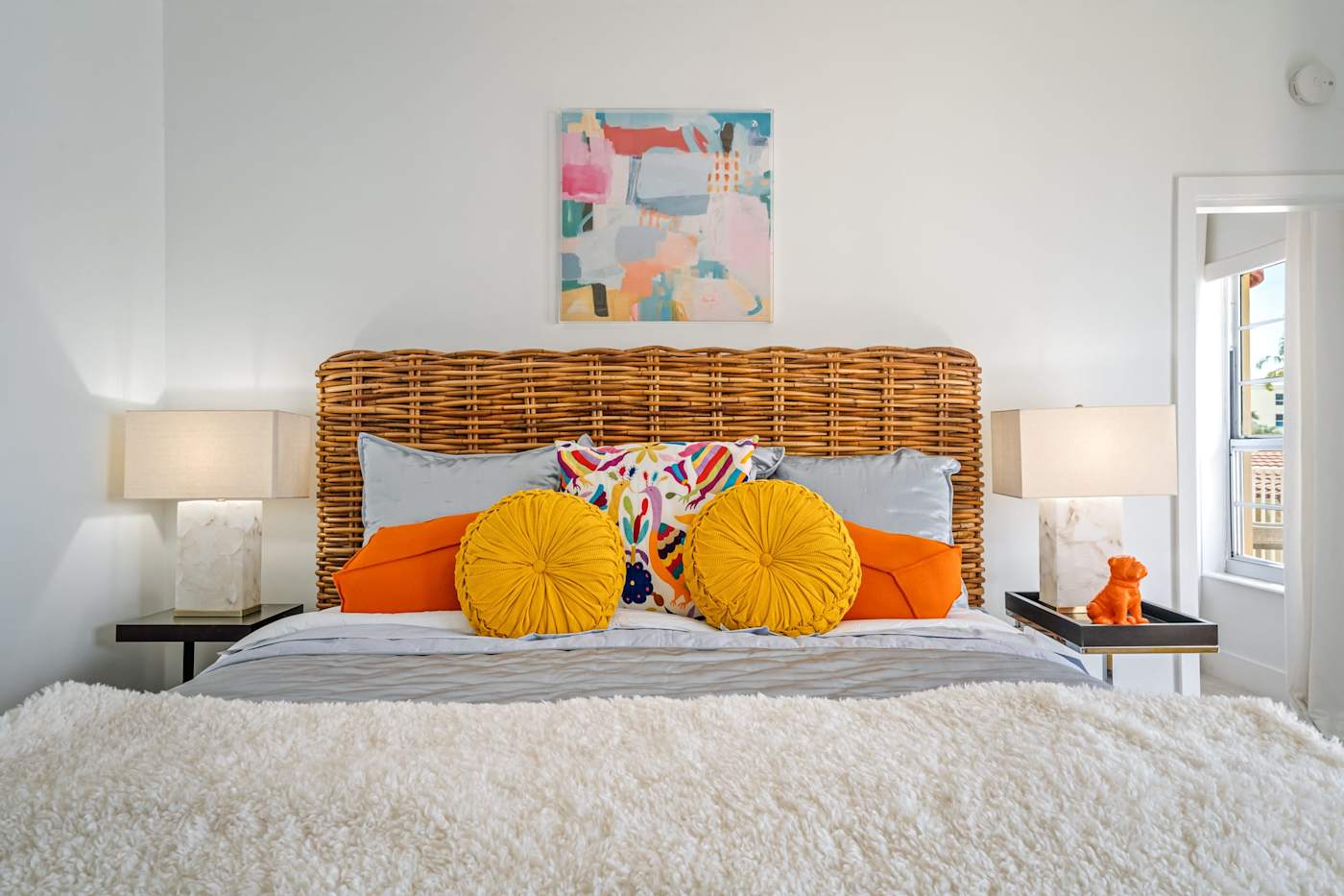 Ocean Block: This bedroom has a bed with a woven headboard and bedside lamps