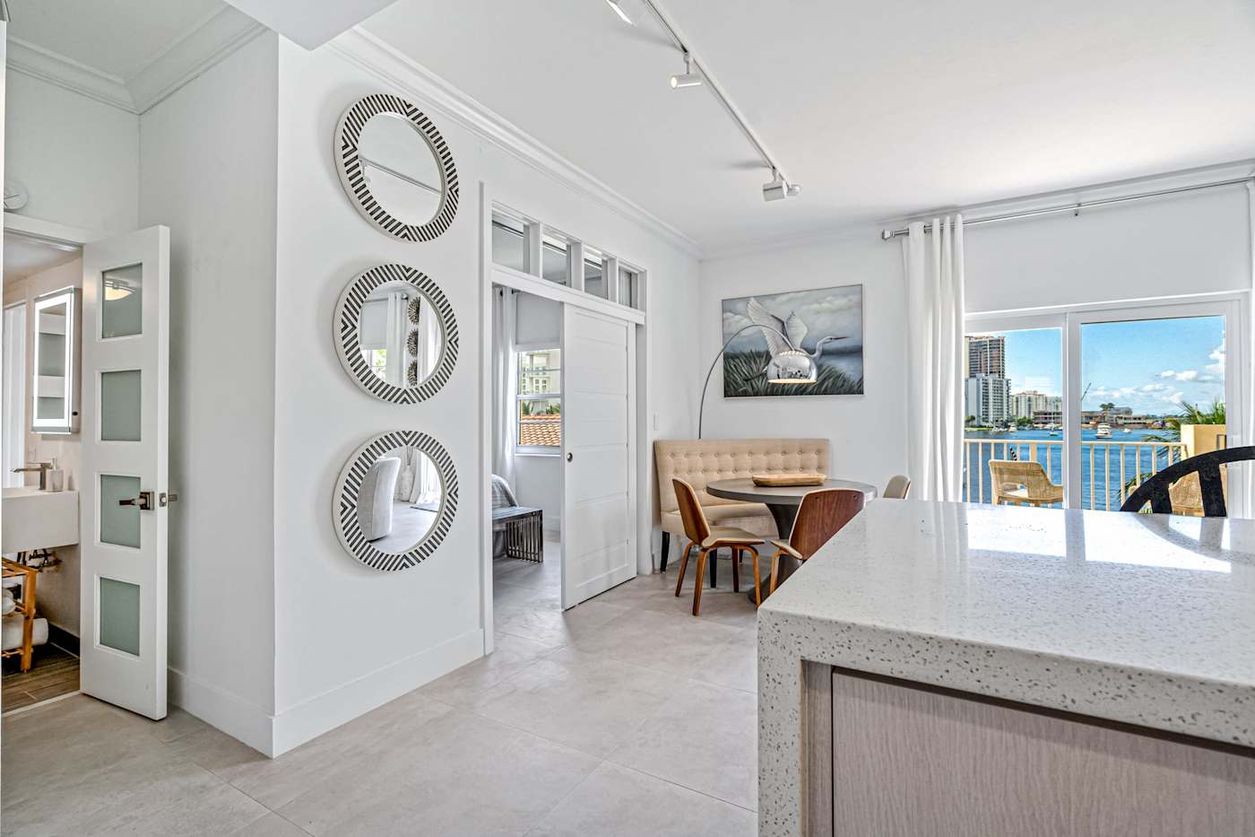 Ocean Block: The dining area and kitchen island look toward the balcony doors
