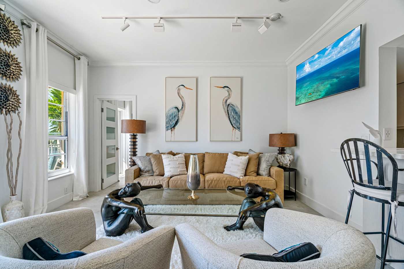 Ocean Block: The living room has a sofa, two armchairs and a wall-mounted Smart TV