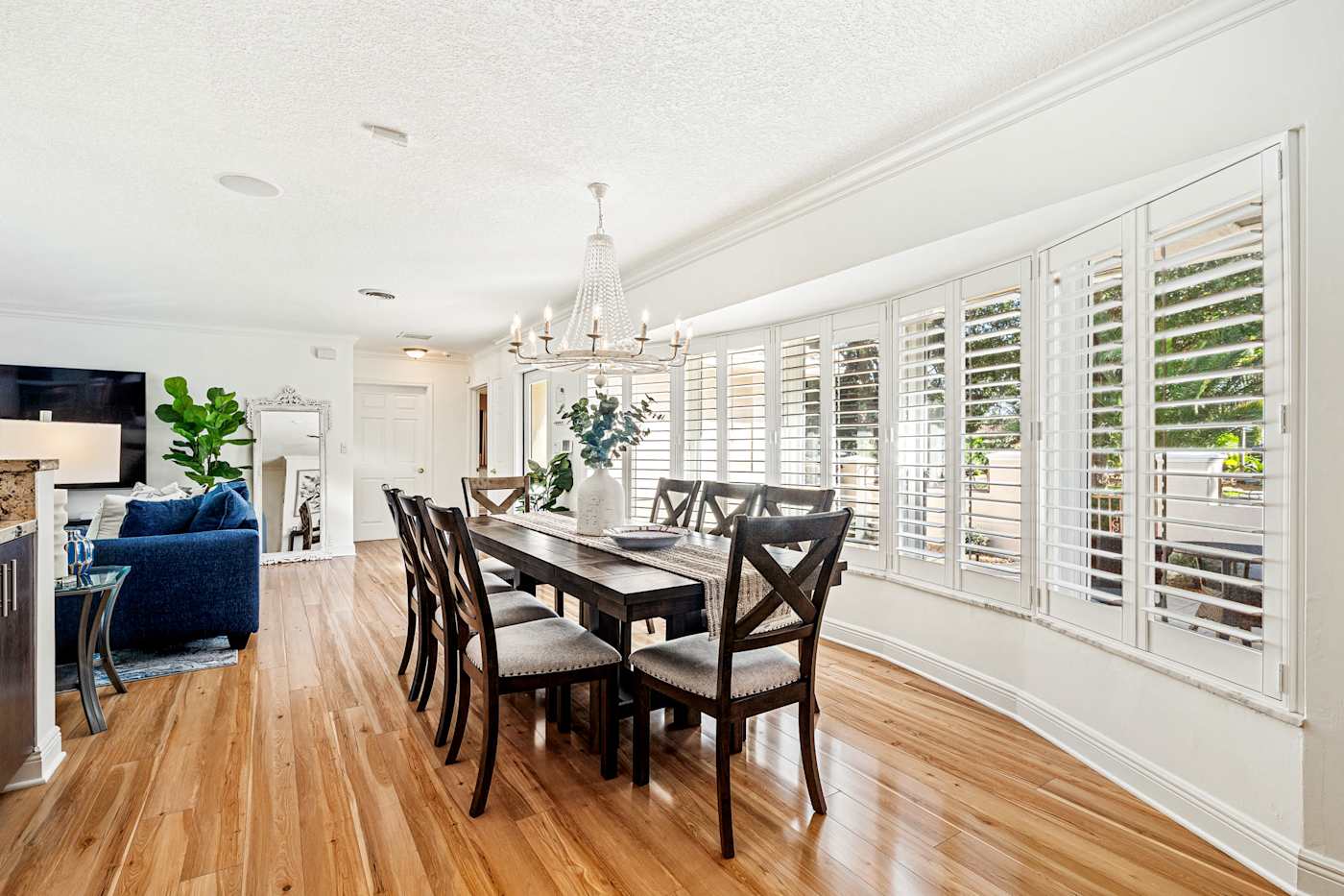Cypress Cove: The long dining table sits beside a wall of shuttered windows