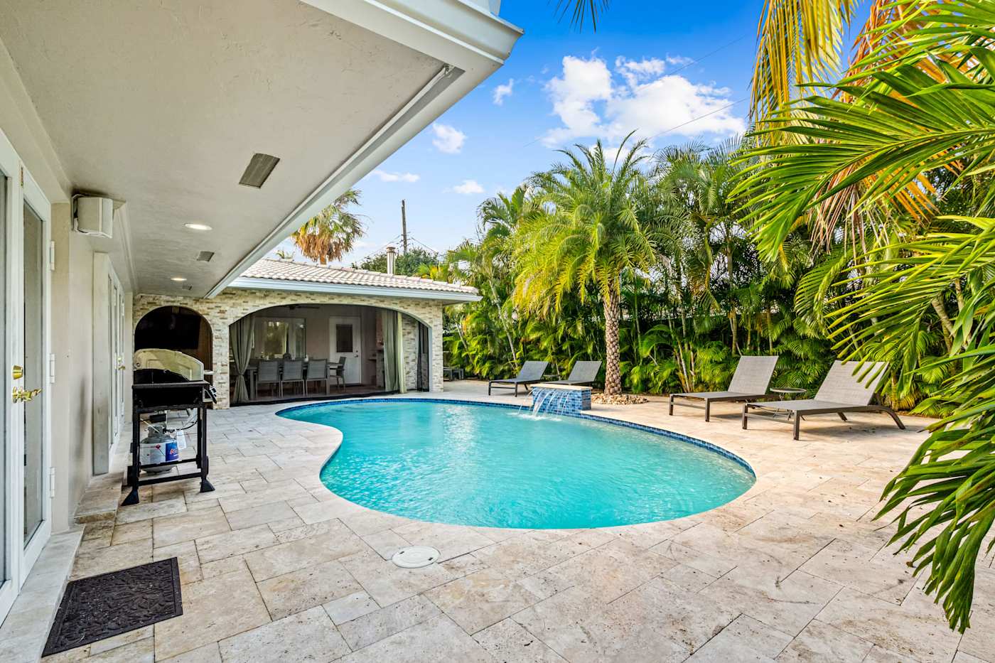 Cypress Cove: The pool is surrounded by palm trees, loungers and a stone deck