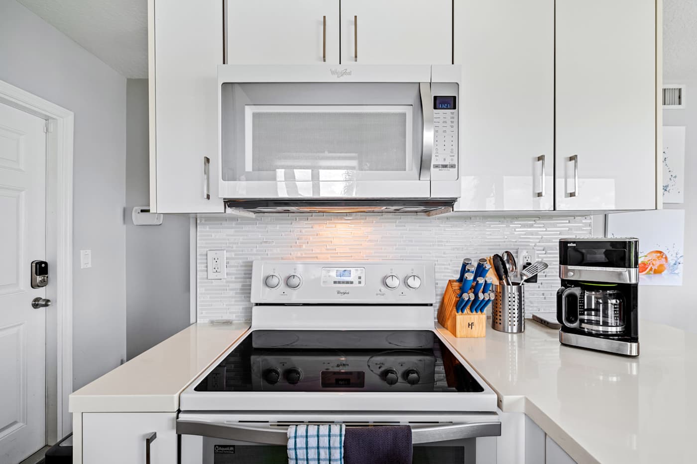 Pompano Condo: The kitchen has a stove, microwave and coffee maker