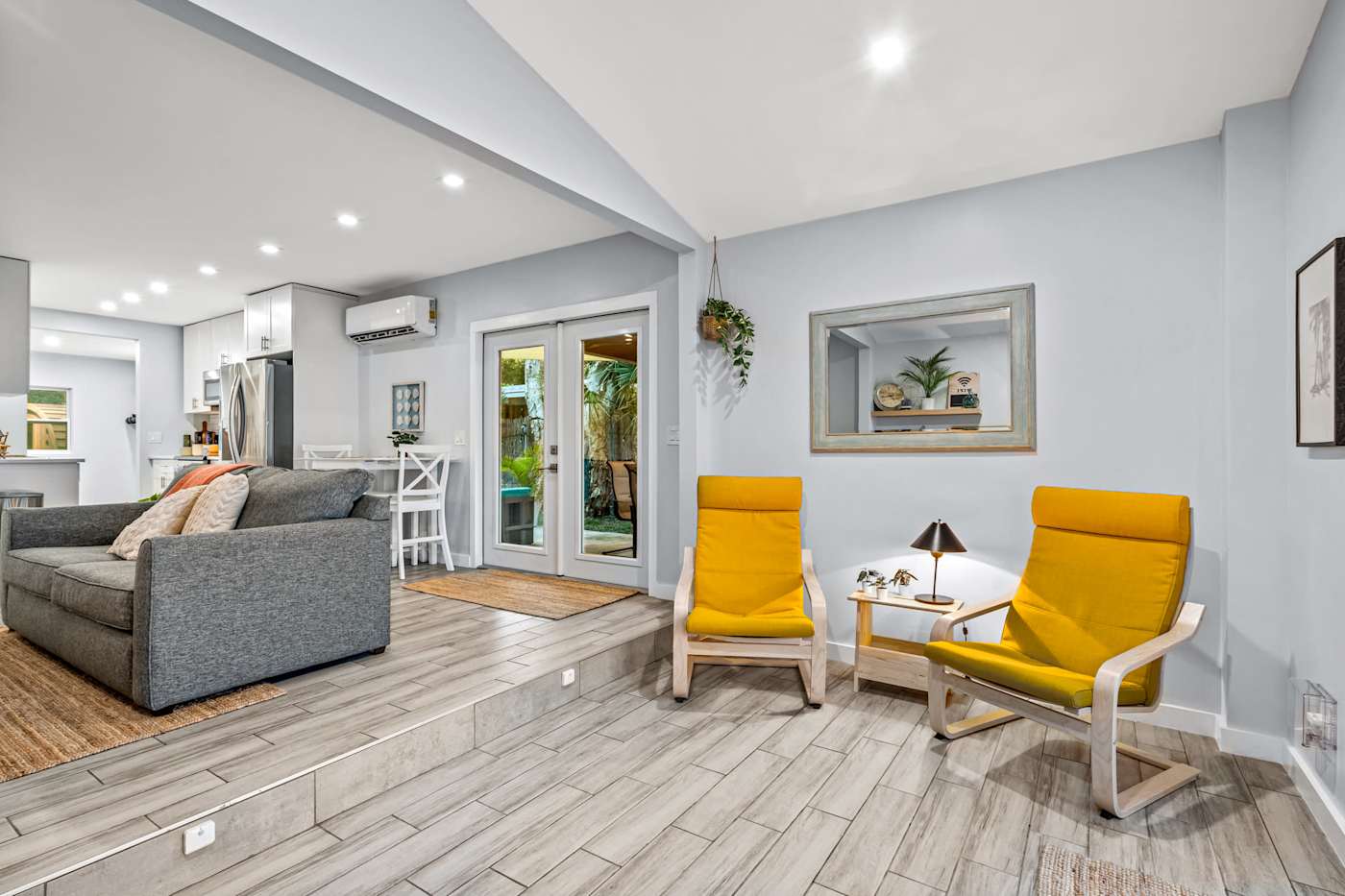 EV Retreat: Two yellow armchairs make a reading nook beside the living room