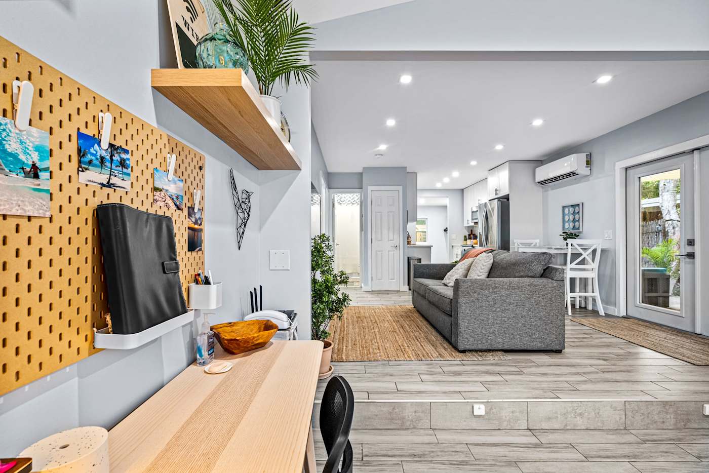 EV Retreat: The workspace has a desk, a pegboard wall and a view into the living room