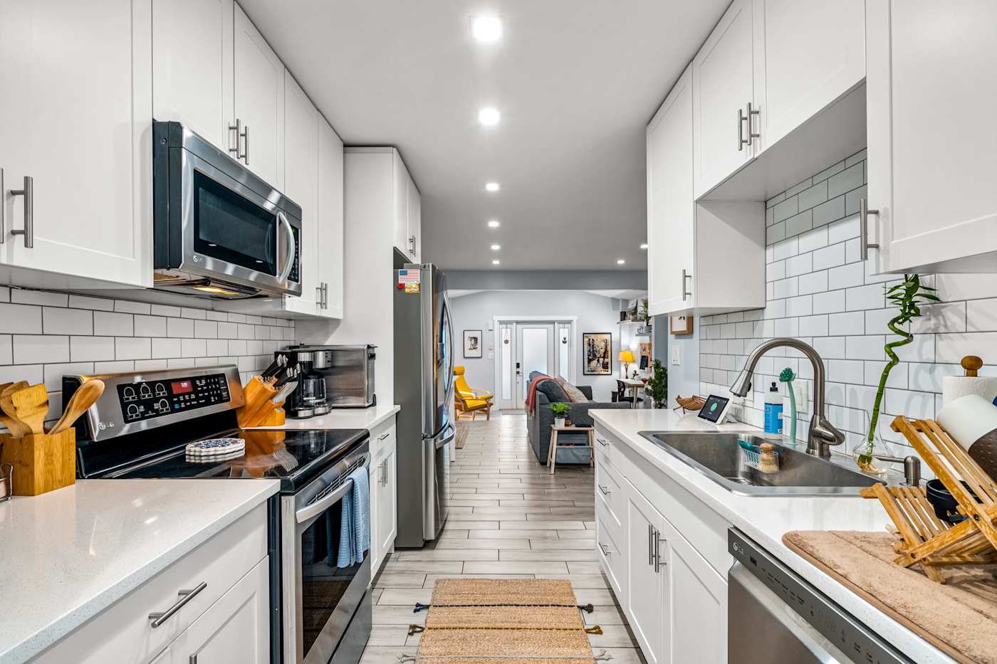 EV Retreat: The kitchen has a stove, microwave and dishwasher, with a view down the hall