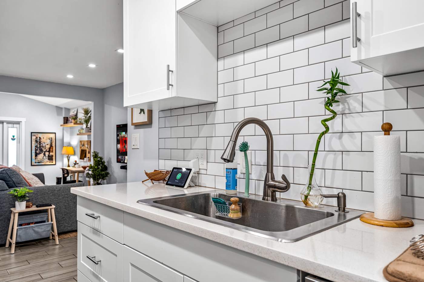 EV Retreat: The kitchen sink sits under white subway tile with a view to the living room