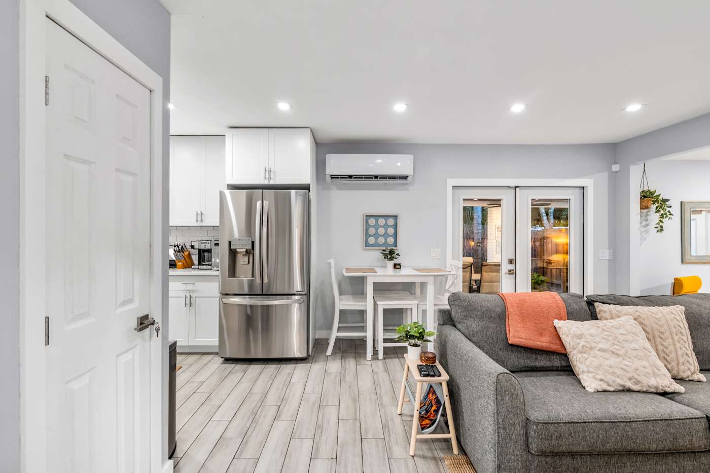 EV Retreat: The living room opens to the kitchen, dining table and French doors
