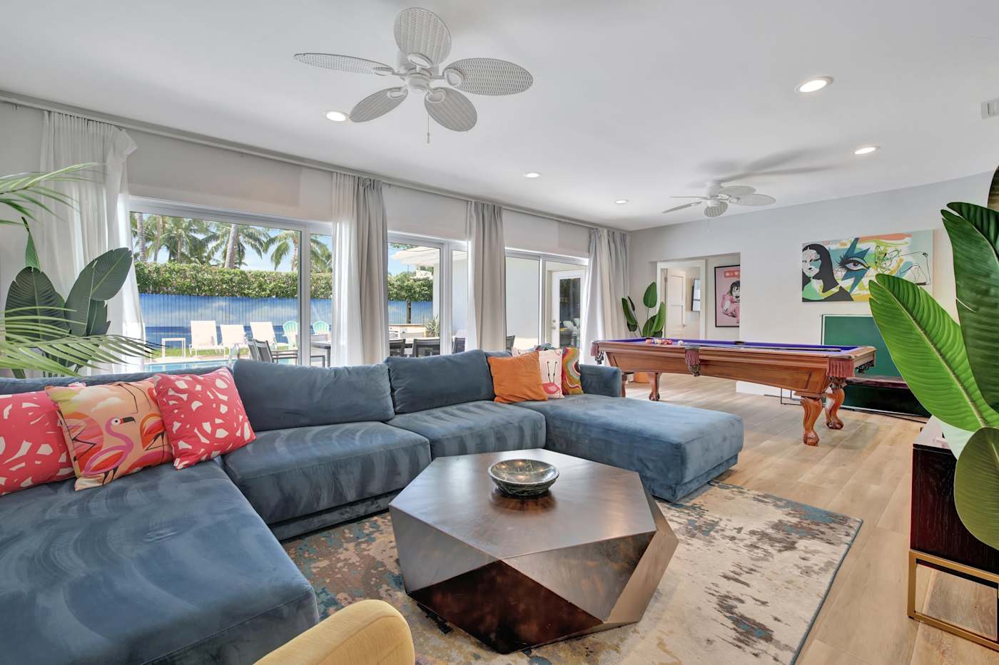 6 Bed Beach House: Living room with sectional, pool table and views to the water