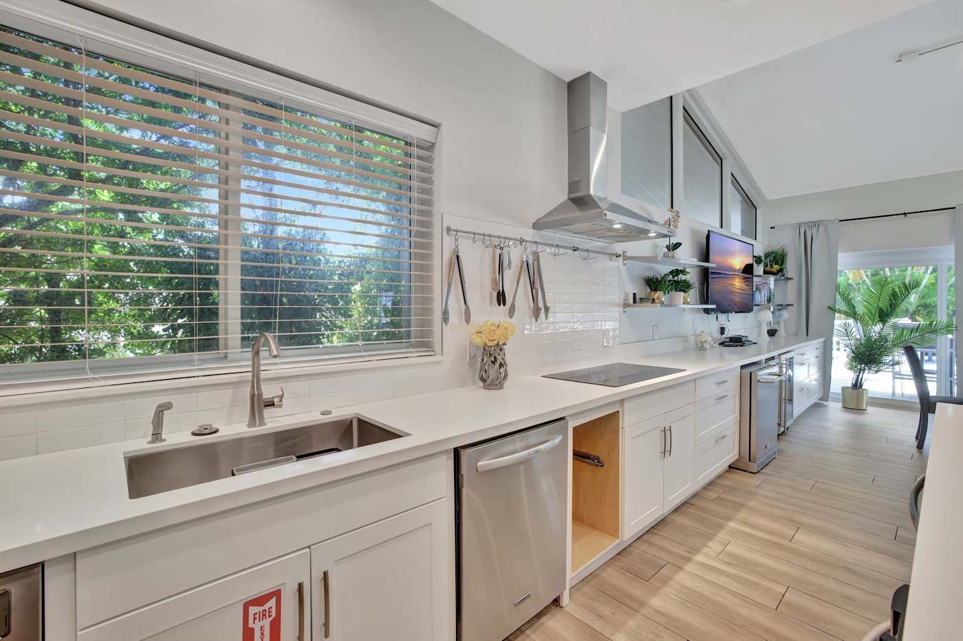 6 Bed Beach House: Kitchen counter with sink, dishwasher and garden view