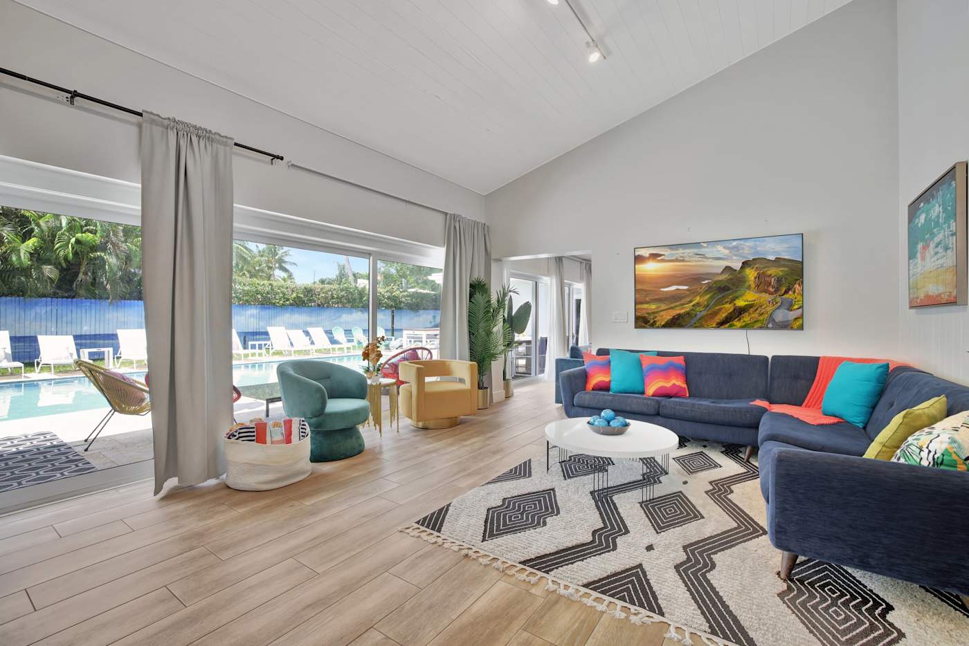 6 Bed Beach House: Open plan living with two seating areas and doors to the pool