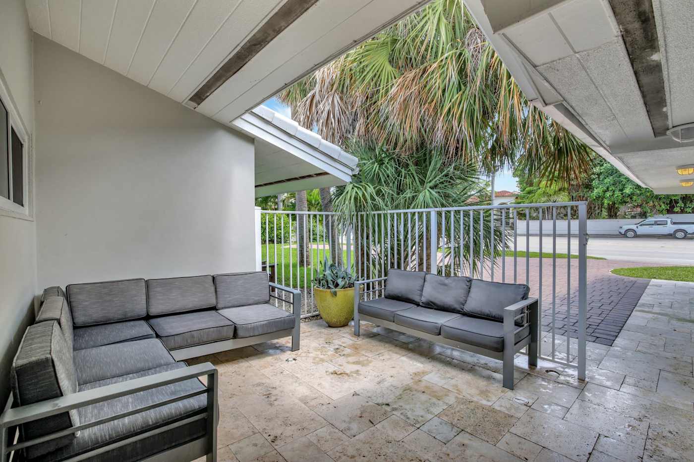 6 Bed Beach House: Covered front terrace with two outdoor sofas