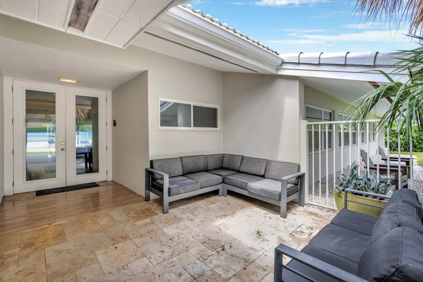 6 Bed Beach House: Covered terrace with outdoor seating by the front door