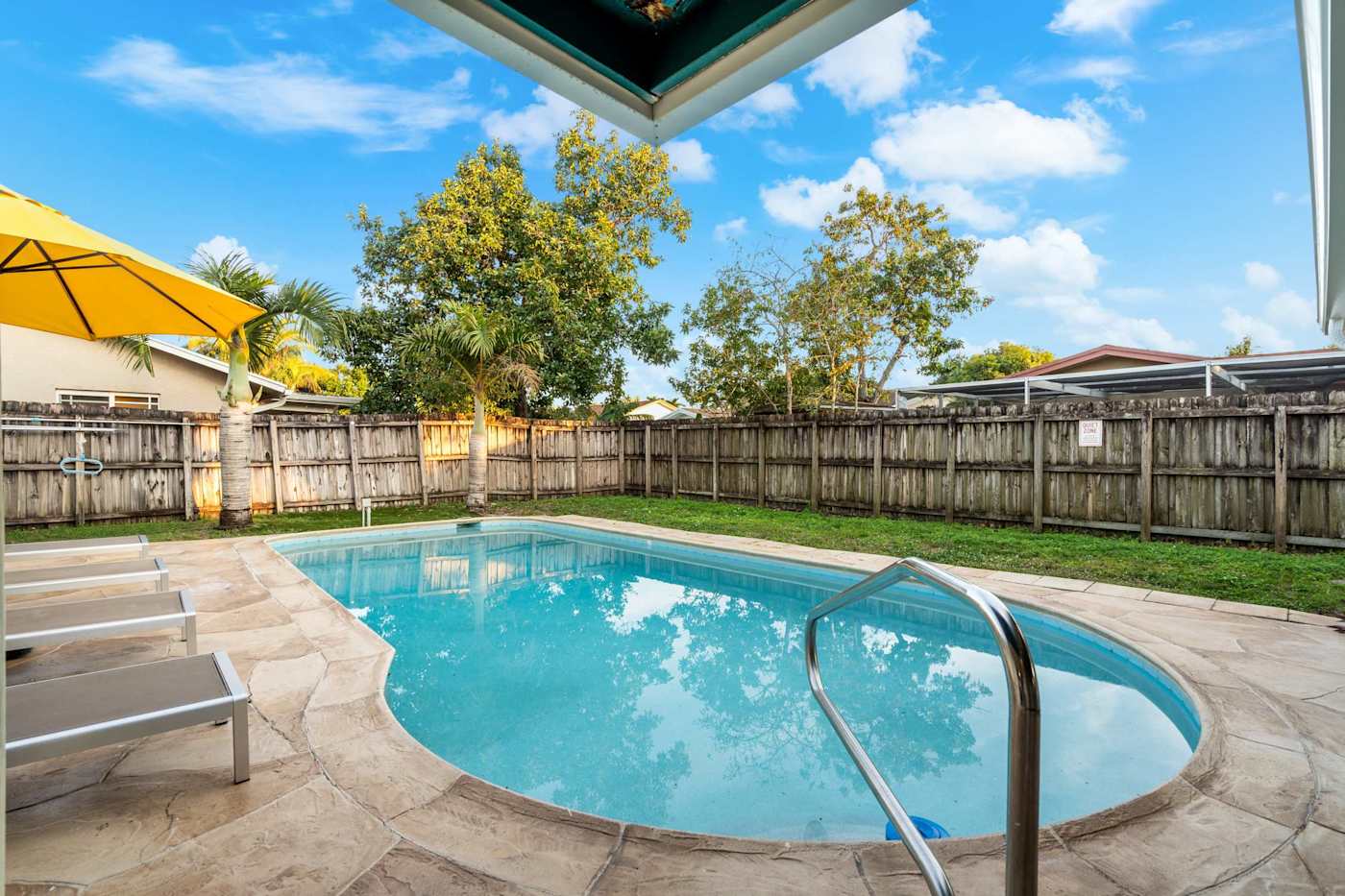 The Game House: Pool and sun loungers on the paved deck