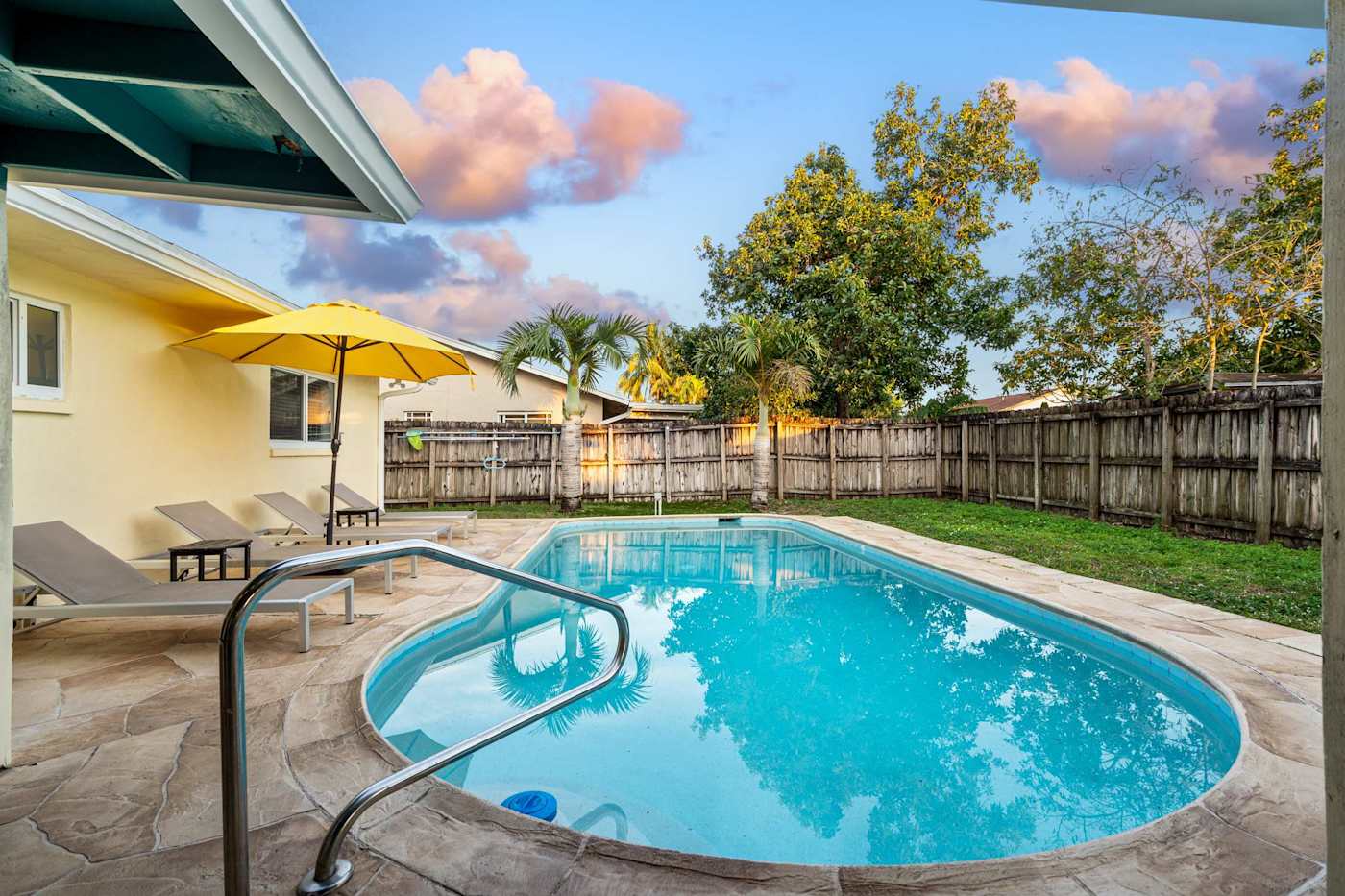 The Game House: Pool with handrail and sun loungers, the house behind