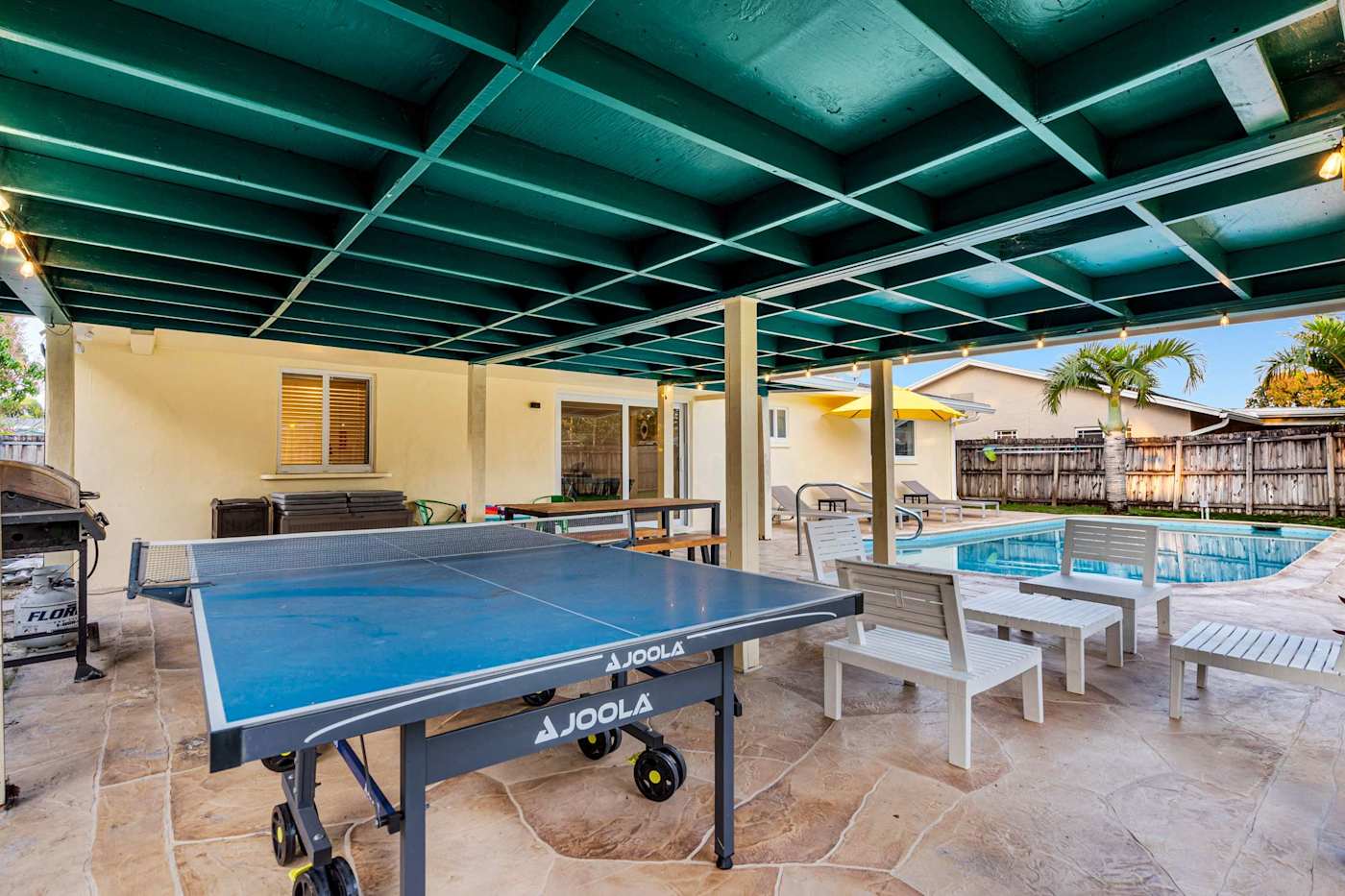 The Game House: Ping pong under the covered patio, with loungers by the pool