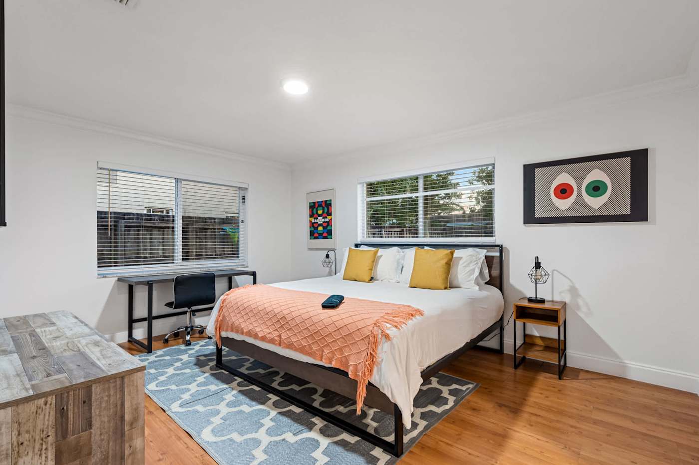 The Game House: Bedroom with king bed, desk and a patterned rug