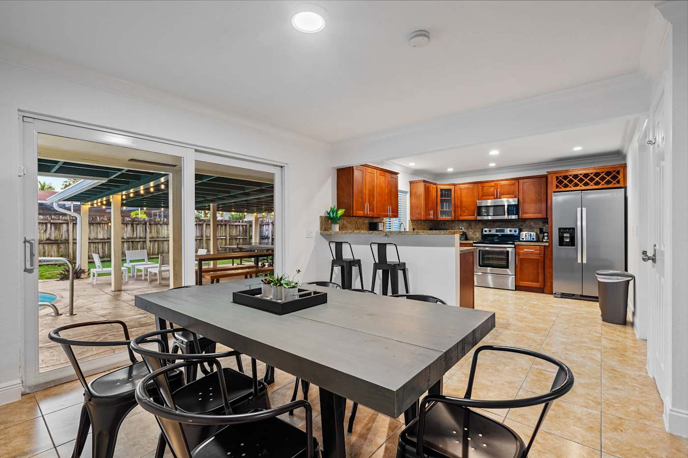 The Game House: Dining table for eight, open to the kitchen and patio doors