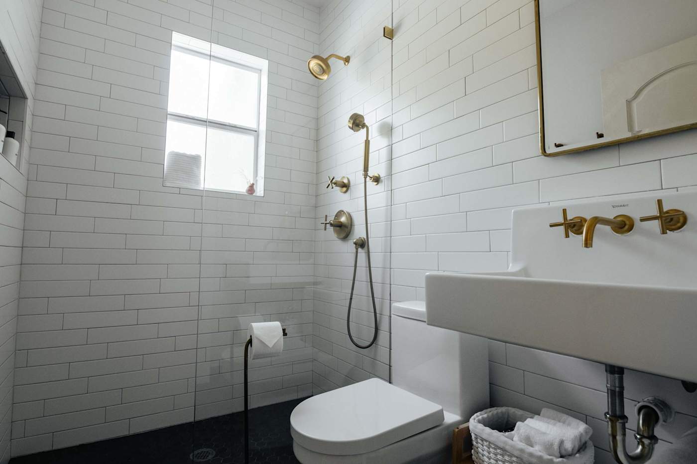 Sol y Sombra: Full bathroom with gold finishes throughout featuring a shower head and hose complete with shampoo, conditioner and body wash for your use