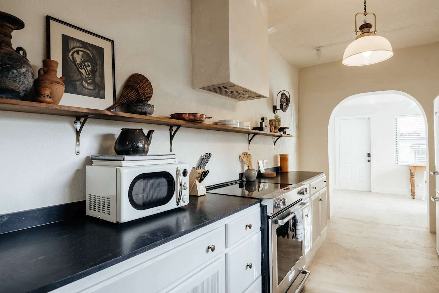 Sol y Sombra: Kitchen including 4 burner Kitchenaid stove with full oven, microwave, cooking utensils and cookbooks