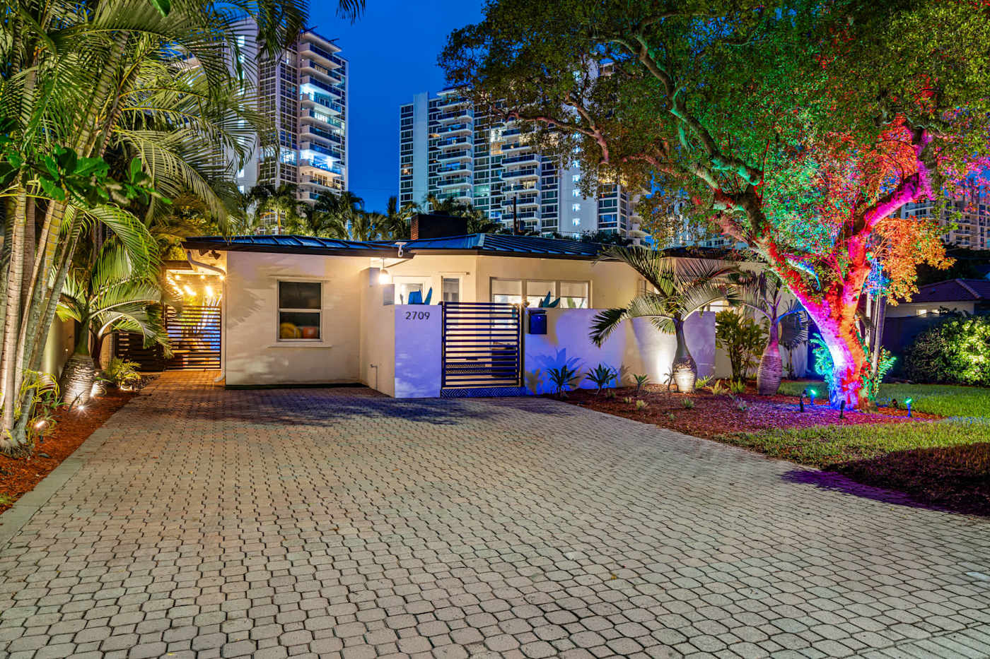 Beach Pop House: The house at dusk with the garden lit