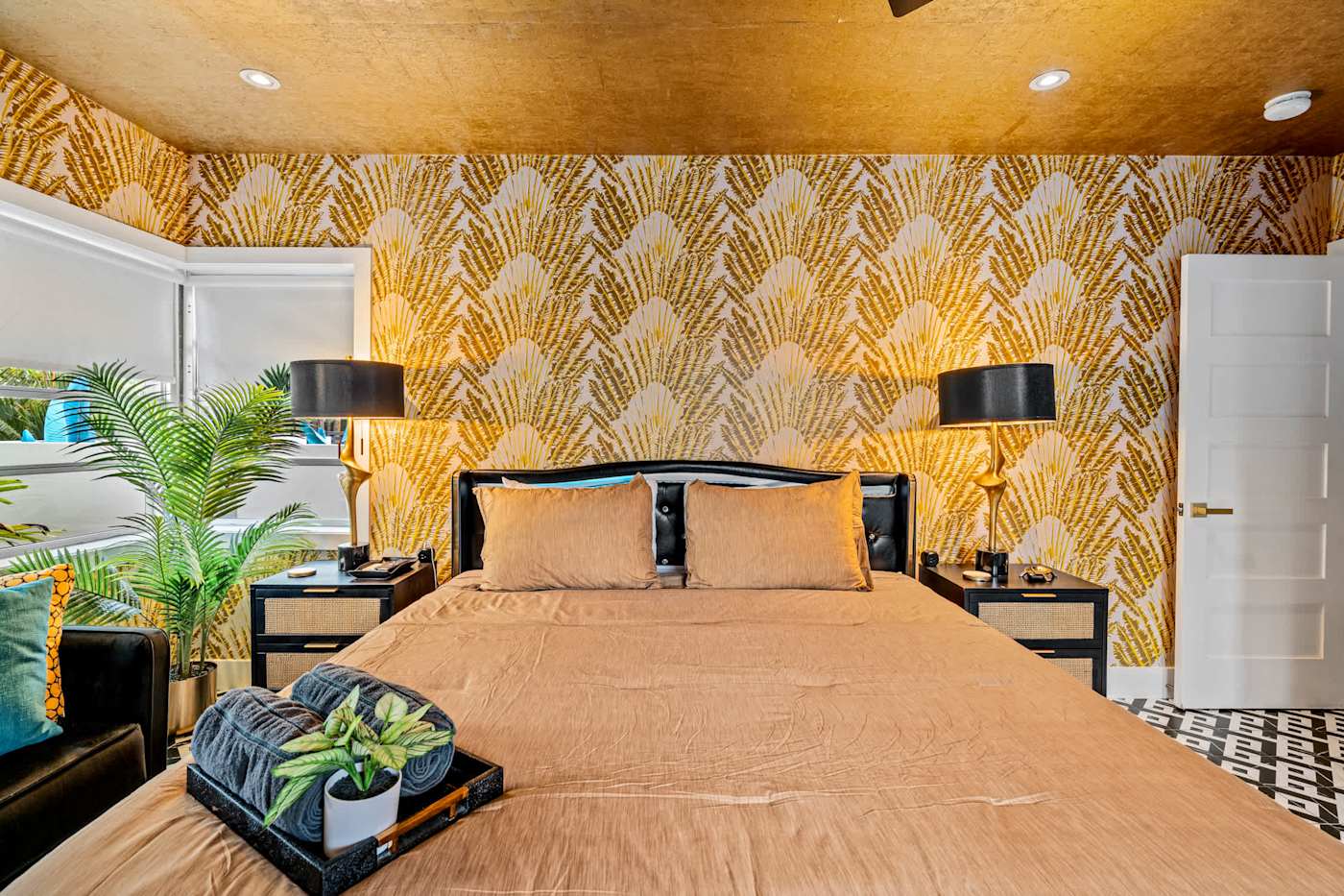 Beach Pop House: King bedroom with gold palm wallpaper and plants