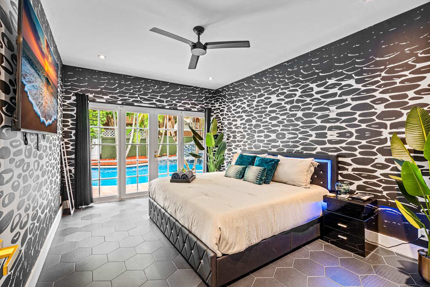 Beach Pop House: King bedroom with pool view and patterned feature wall