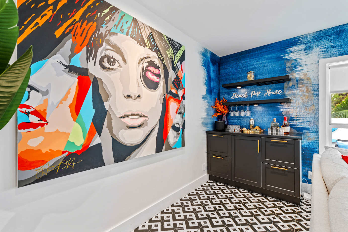 Beach Pop House: Bar area with pop art and dark cabinetry
