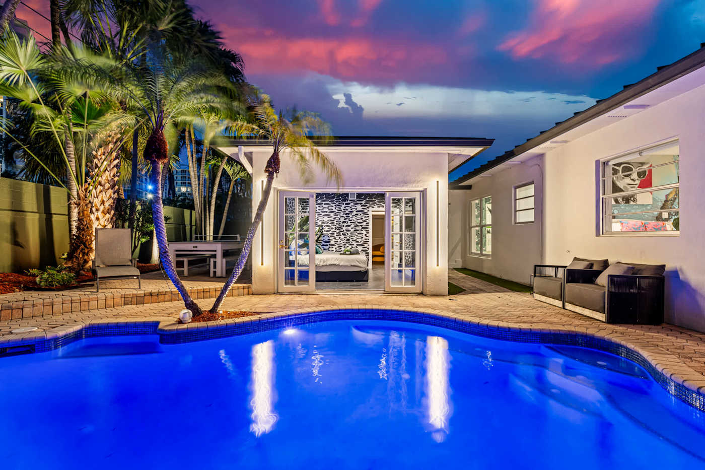 Beach Pop House: Heated pool lit at dusk, with a basketball hoop on the deck