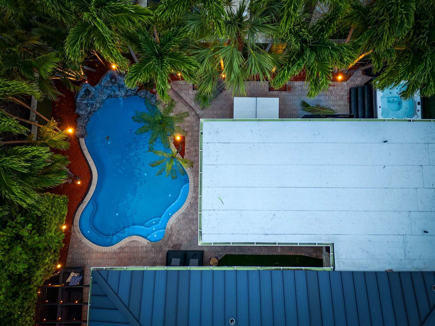 Beach Pop House: The pool lit at night, from above
