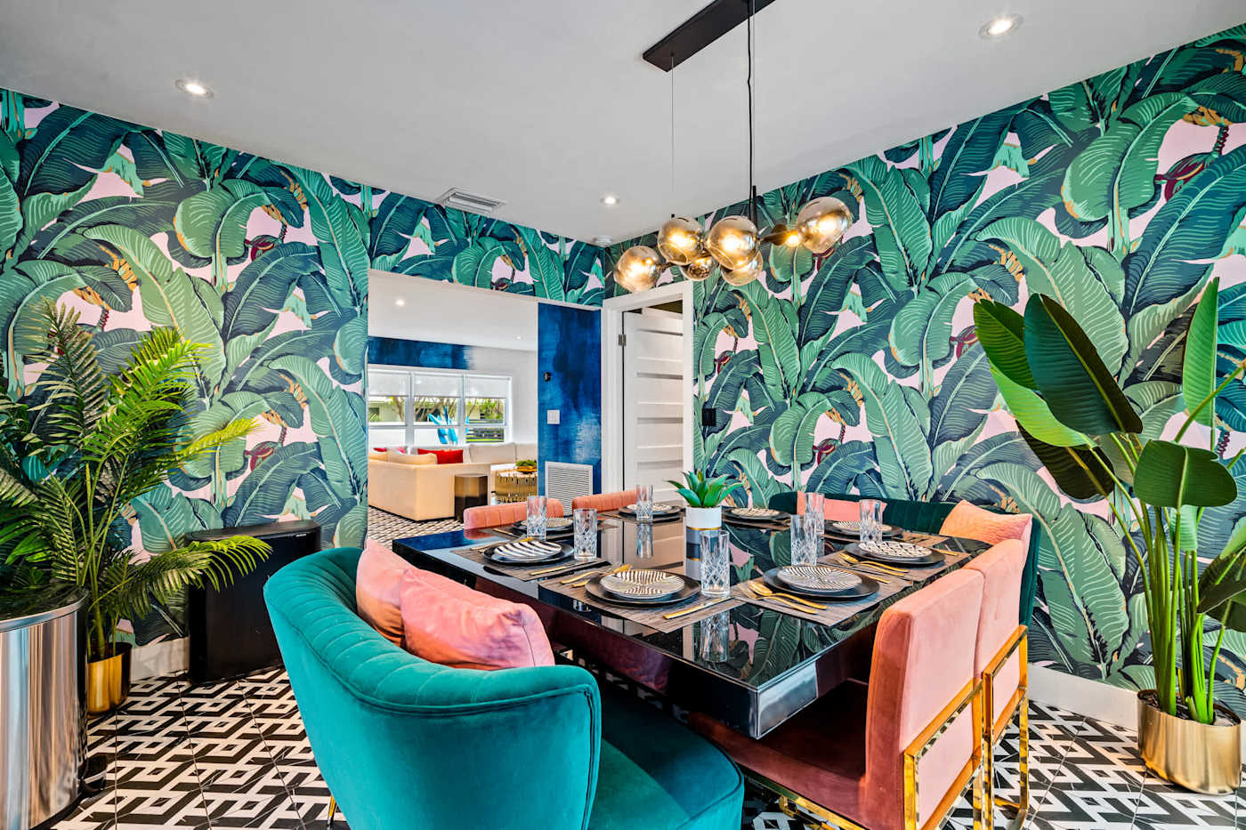 Beach Pop House: Dining table set for six under banana leaf wallpaper
