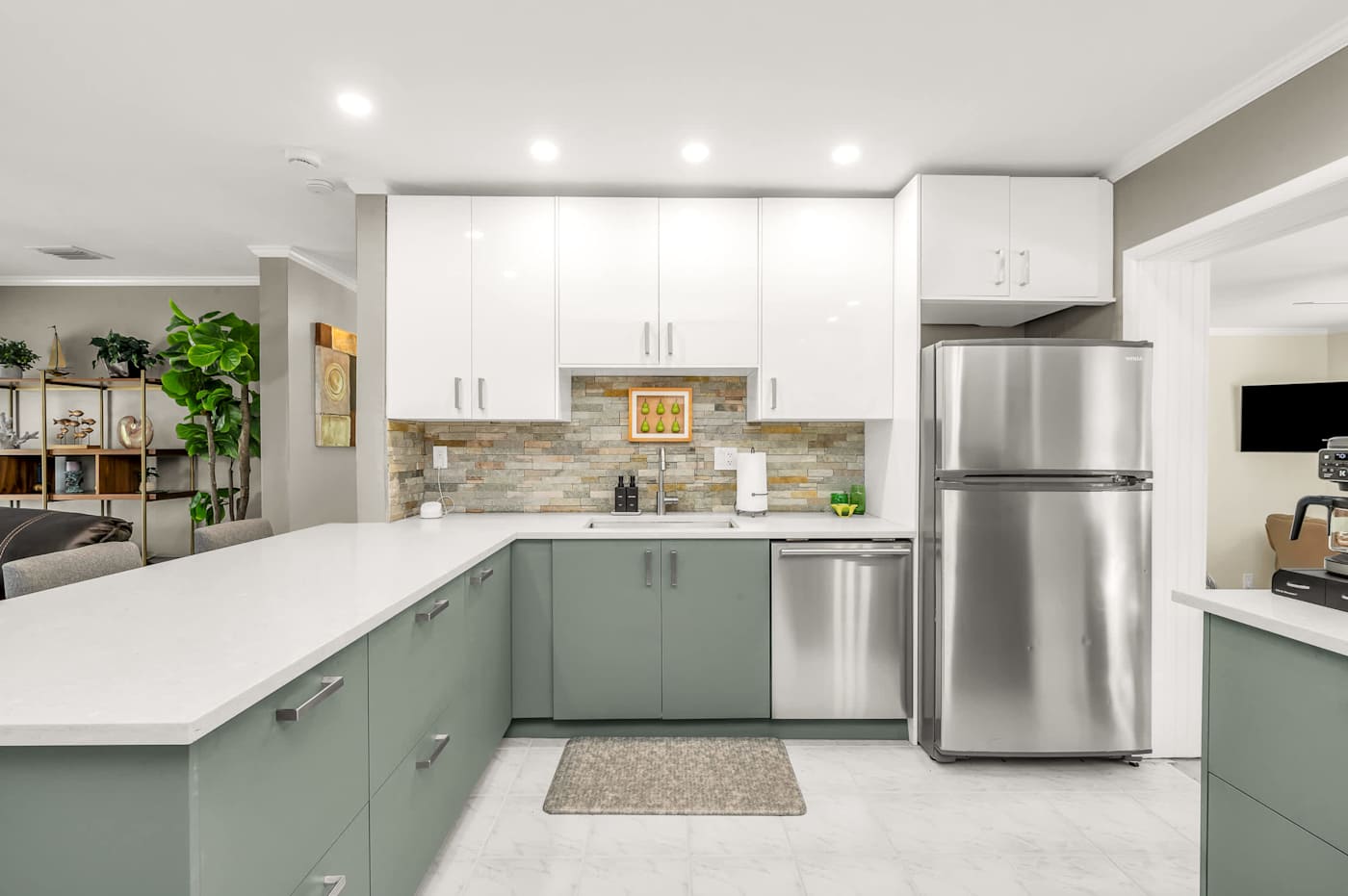 The Fairway: Kitchen with green cabinets, dishwasher and fridge freezer
