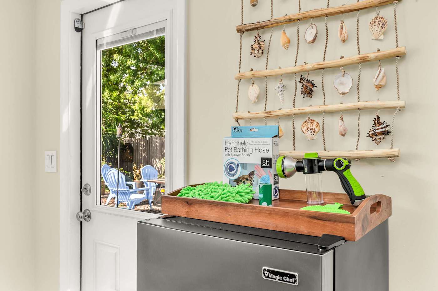 The Fairway: Back door with a drinks fridge and a pet bathing hose
