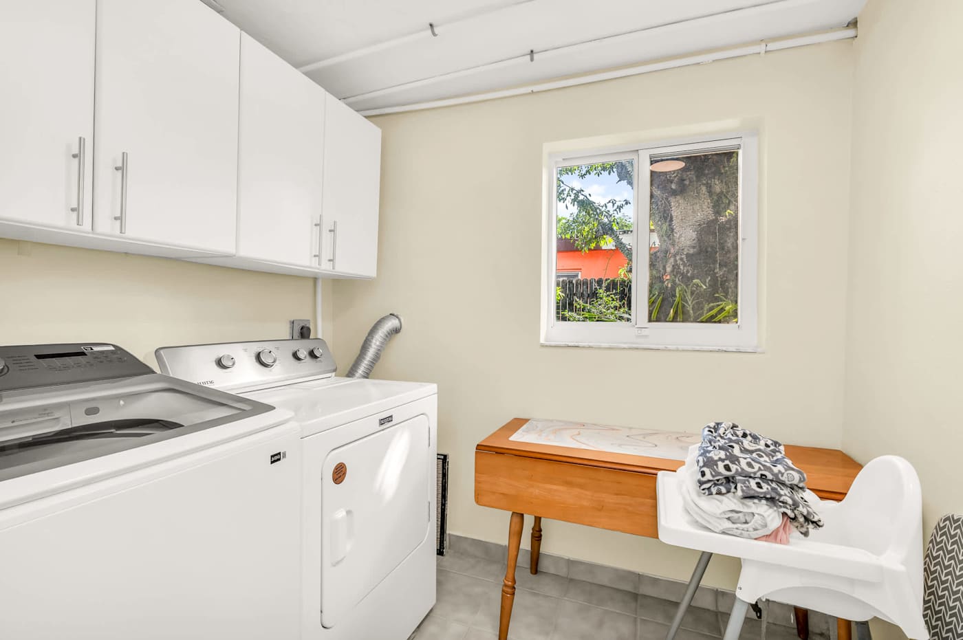 The Fairway: Utility room with washer, dryer and a high chair