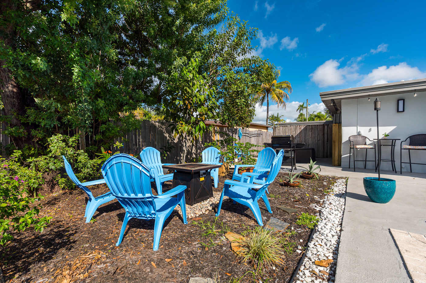 The Fairway: Fire pit table with Adirondack chairs, in the shade