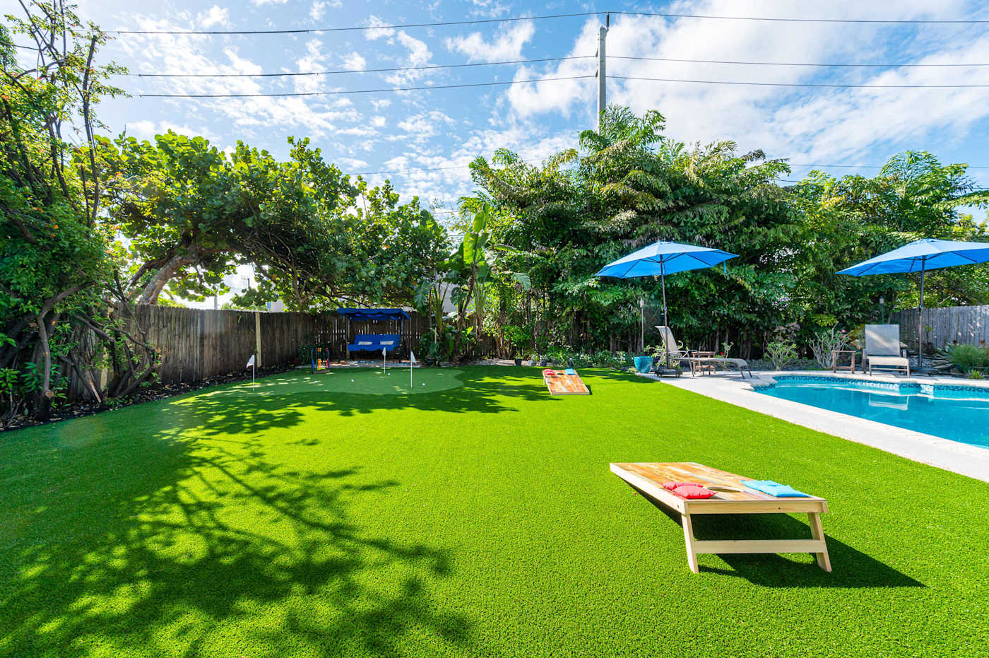 The Fairway: Lawn with cornhole, the putting green and pool beyond