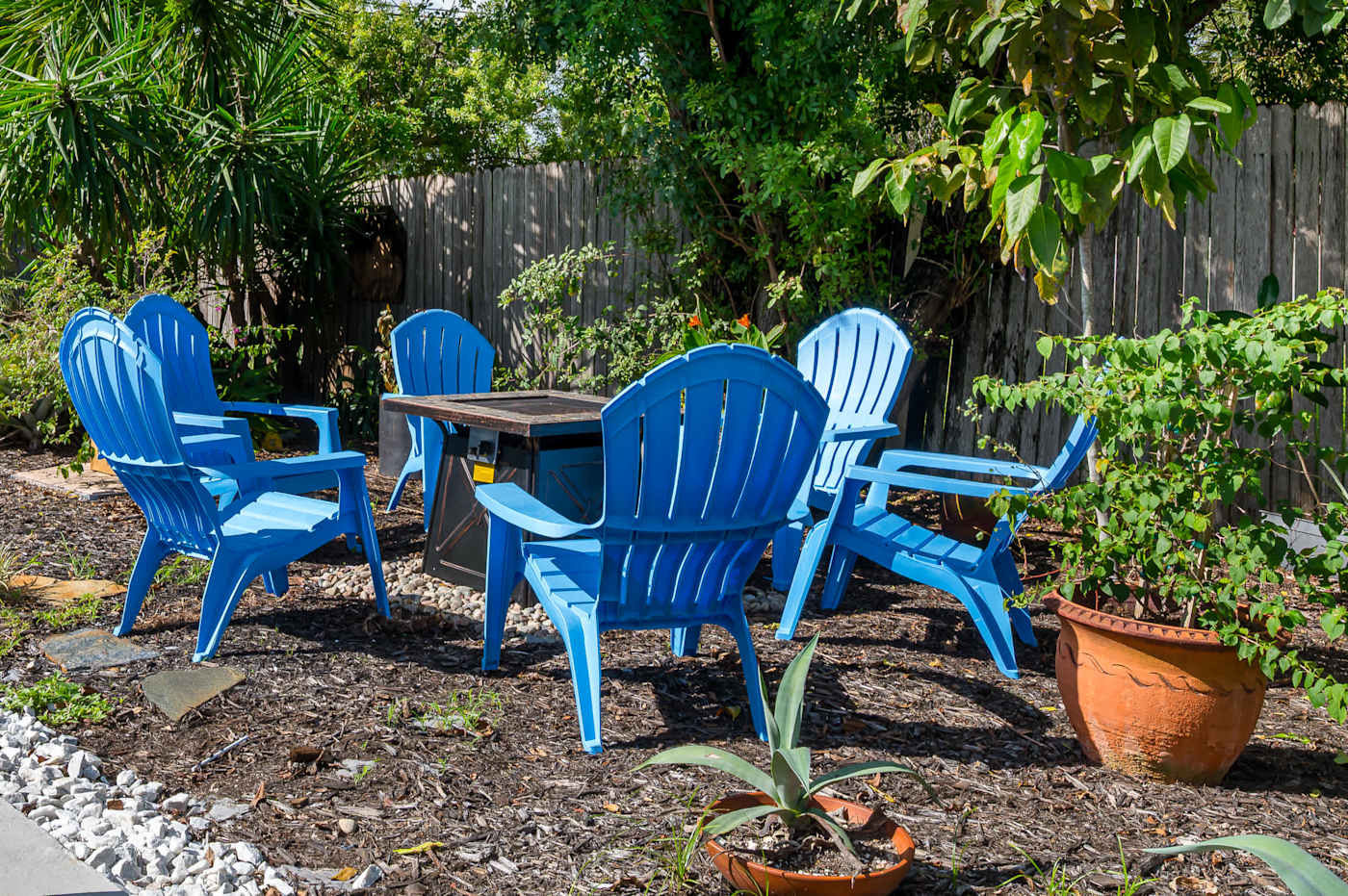 The Fairway: Fire pit table and Adirondack chairs in the garden