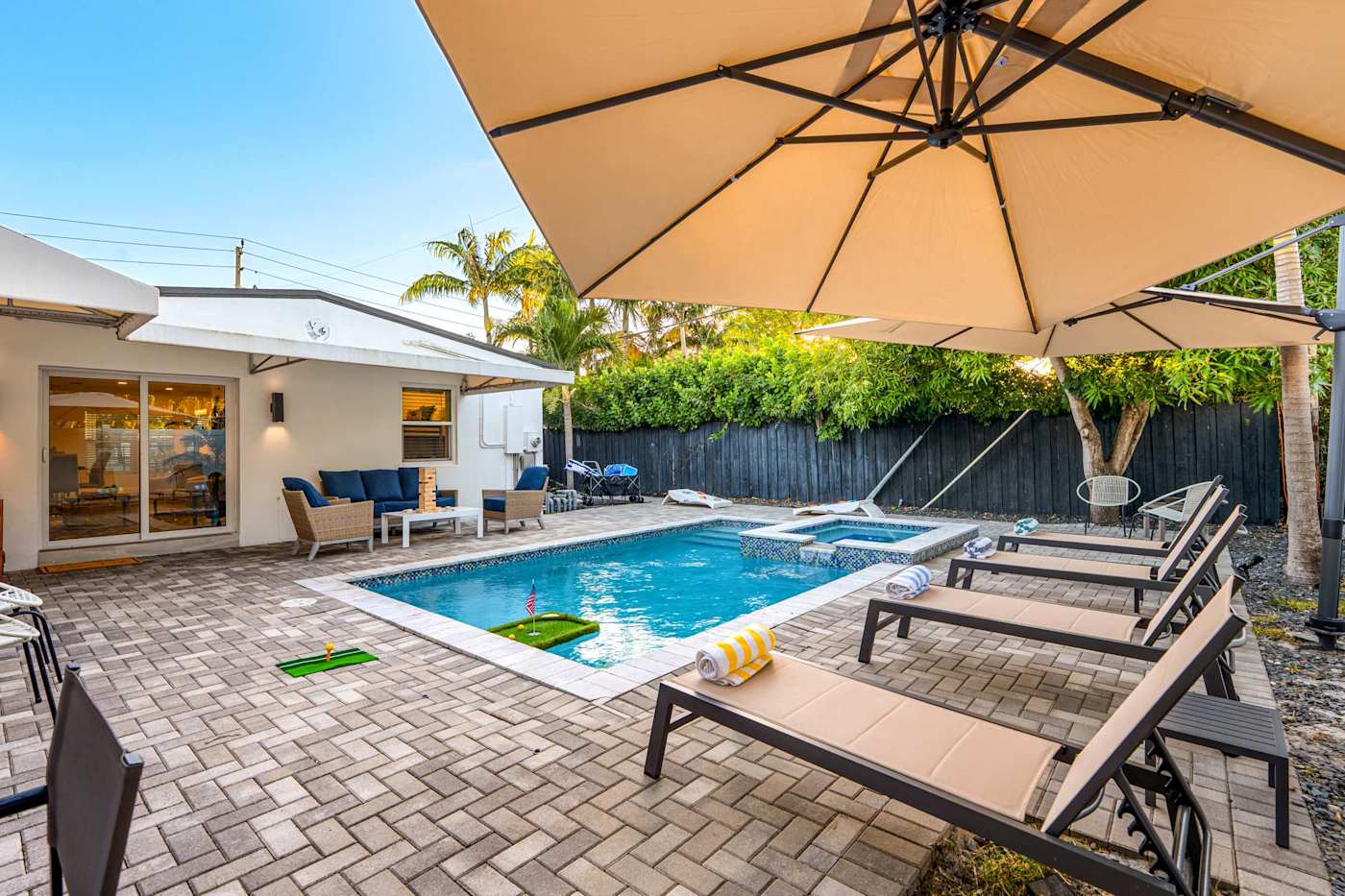 Casa Pura Vida: Pool deck at sunset with umbrellas up