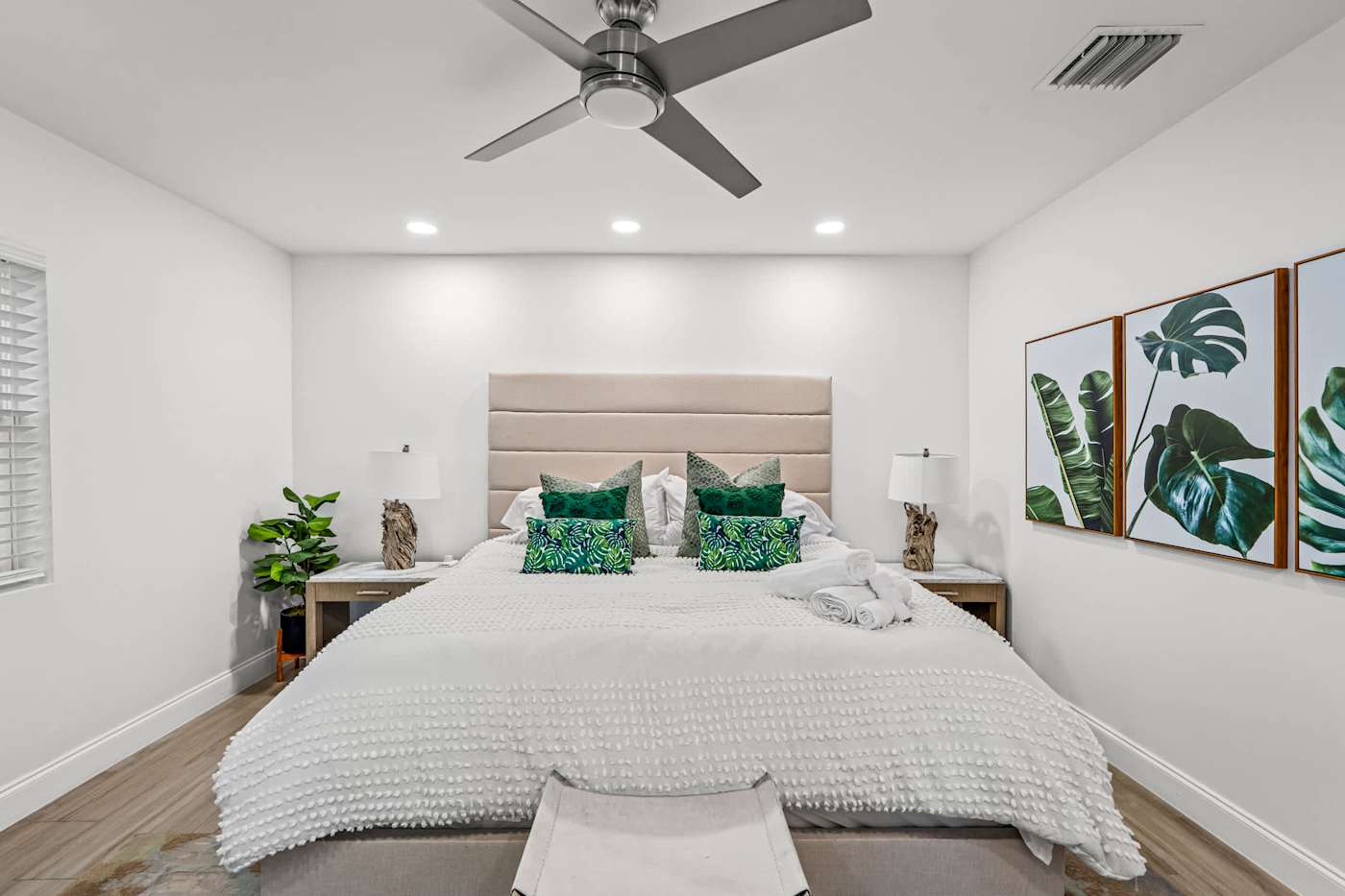 Casa Pura Vida: Bedroom with king bed, ceiling fan and framed prints