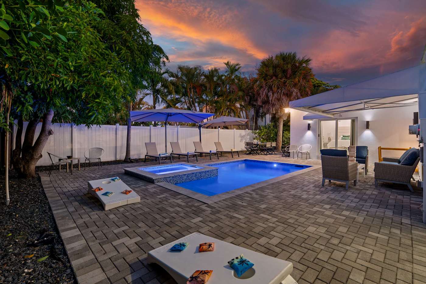 Casa Pura Vida: Pool and hot tub at sunset, with cornhole on the deck