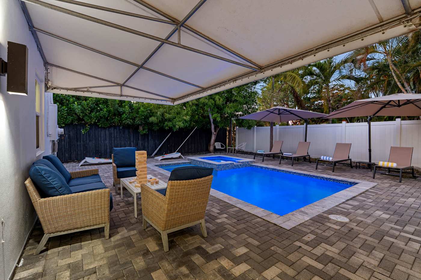 Casa Pura Vida: Covered lounge with armchairs and a table, beside the pool